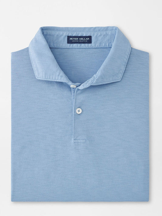 A folded Peter Millar Journeyman Short Sleeve Polo in Angelite—light blue, lightweight and casual, featuring a collar, two buttons, and an inside neck label.