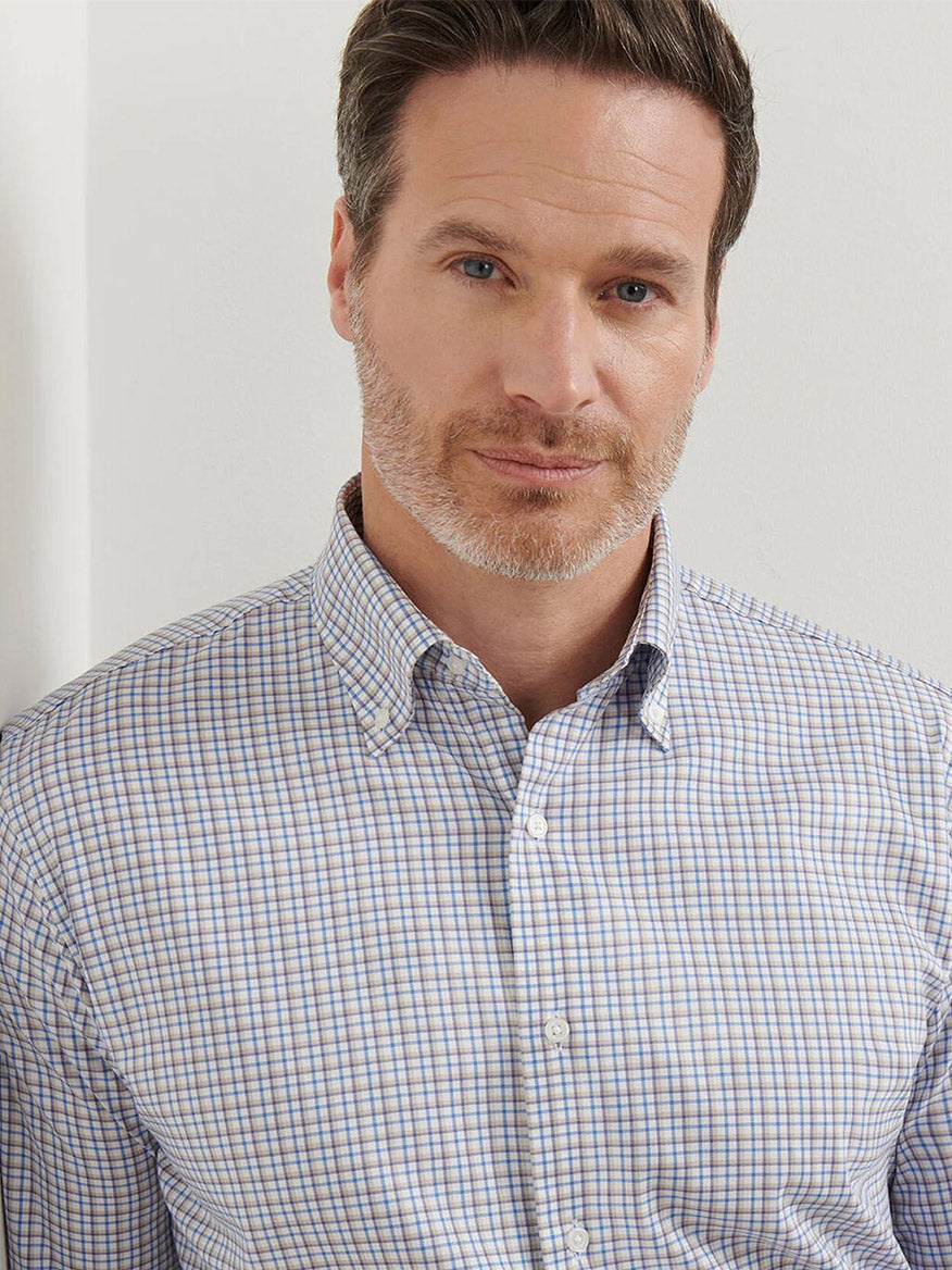A man with short brown hair and a trimmed beard wears the Peter Millar Julian Crown Lite Cotton-Stretch Shirt in Evening Tide, standing in front of a white background.