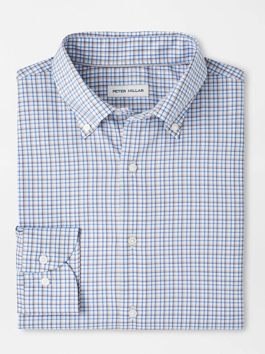 The Peter Millar Julian Crown Lite Cotton-Stretch Shirt in Evening Tide is a folded long-sleeve, classic-fit shirt with blue and brown checks, easy-care fabric, a front pocket, and an interior Peter Millar label.
