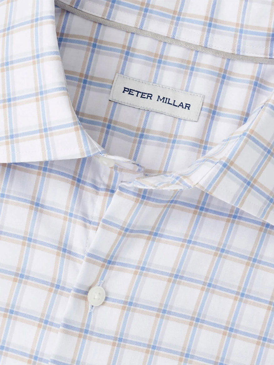 Close-up of the Peter Millar Lenox Crown Lite Cotton-Stretch Sport Shirt in White, featuring a light plaid pattern with blue and tan lines, classic collar, branded label, and easy-care fabric for a comfortable fit.