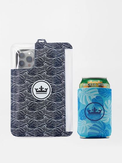Smartphone with a Peter Millar Linework Monstera Swim Trunk in Seasalt case next to a matching blue can of wicked weed beverage.