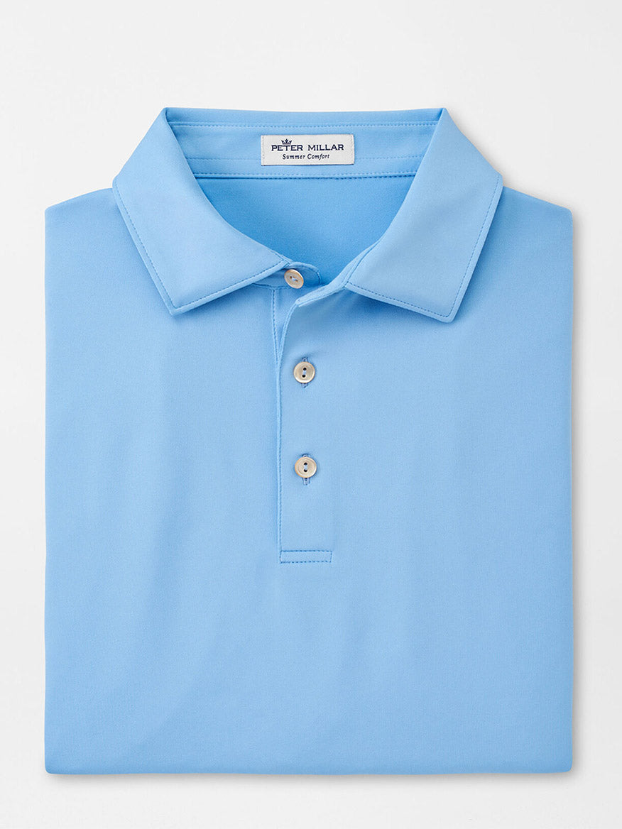 Light blue Peter Millar Solid Performance Jersey polo shirt neatly folded with a view of the collar and top buttons, perfect for the golf course.