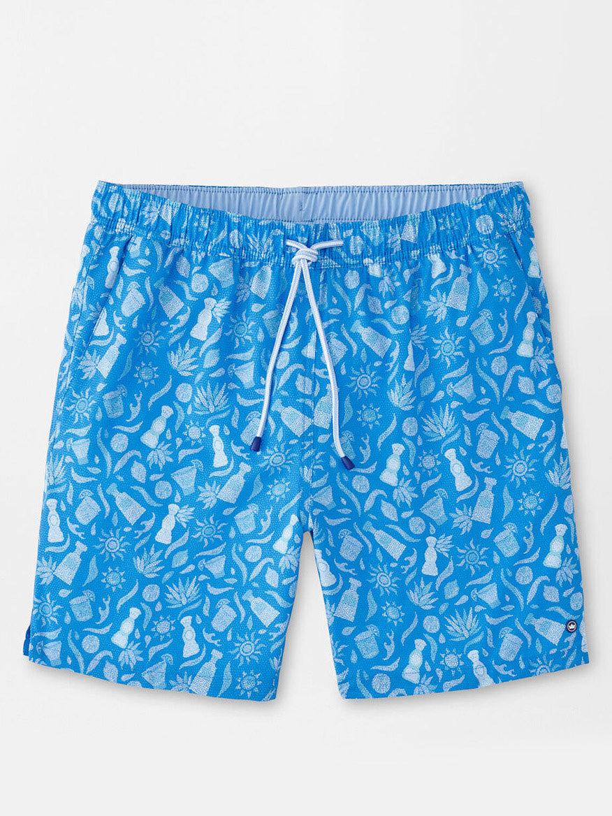 The Peter Millar Saltwater Spirits Swim Trunk in Blue Macaw features blue swim shorts with a white drawstring and an exclusive hand-designed print of pineapples, suns, and tropical drink silhouettes. Enjoy ultimate comfort and style with four-way stretch fabric in the sun.