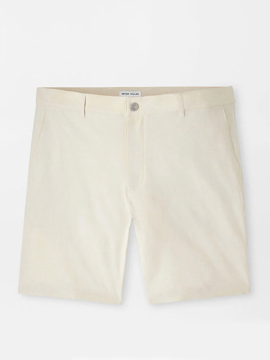 Peter Millar Shackleford Performance Hybrid Short in Sand: beige, knee-length, water-resistant shorts with belt loops, side pockets, and a button closure shown on a plain white background.