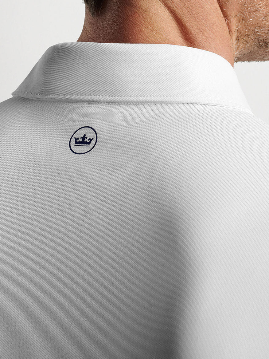 Close-up view of a Peter Millar Soul Performance Mesh Polo in White collar with a small logo on the back, made of wicking mesh fabric.