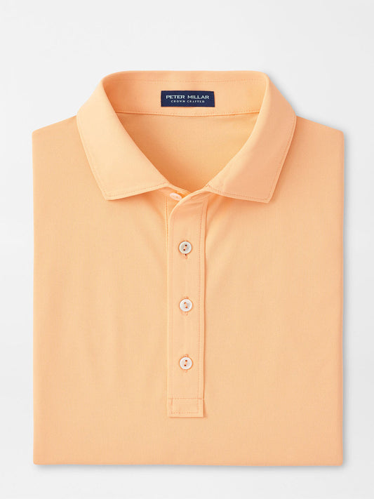 Peter Millar Soul Performance Mesh Polo in Orange Sorbet with a close-up on the collar and top buttons, featuring wicking mesh fabric.