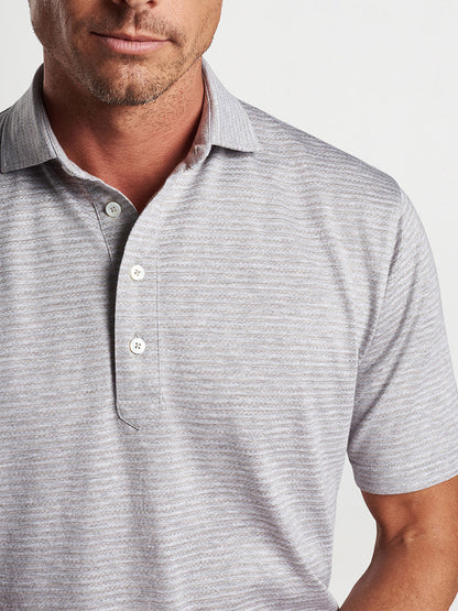 Close-up of a man in a Peter Millar Tidewater Stripe Polo in British Grey.