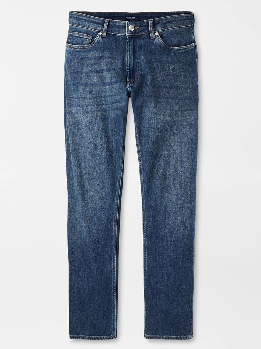 Peter Millar Vintage Washed Five-Pocket Denim in True Blue Wash, featuring a tailored fit, straight leg, button and zipper closure, five pockets, and an Italian leather back patch, displayed flat on a white background.