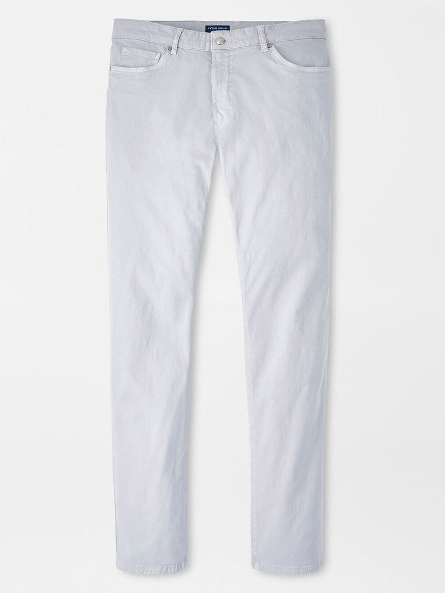 The Peter Millar Wayfare Five-Pocket Pant in Platinum is a light gray, slim-fit, wrinkle-resistant pant with a button and zip closure and classic five-pocket design, displayed against a white background.