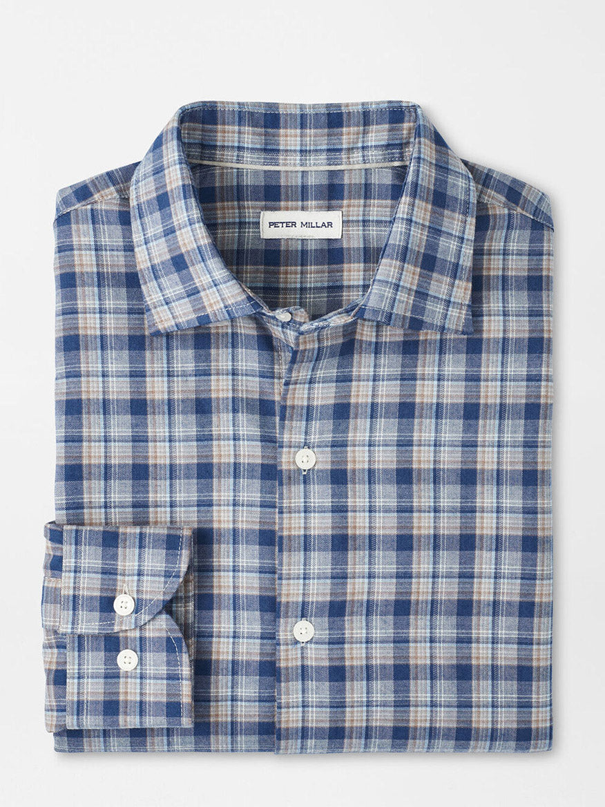 The Peter Millar Whitecap Performance Flannel Sport Shirt in Blue Haze features blue, white, and beige plaid, a visible label, and a comfortable fit—your ideal button-up for fall, displayed on a plain white background.