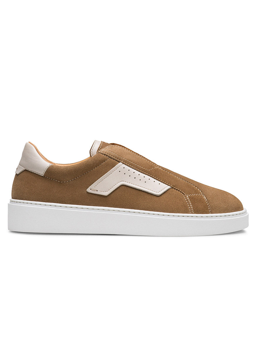 The Magnanni Phoenix Slip in Taupe Suede, featuring white leather accents and a white sole, showcases sporty appeal and contemporary style when viewed from the side.