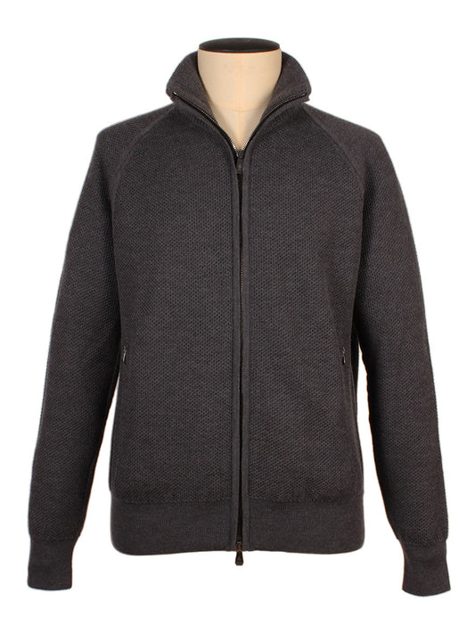 The Piacenza 1733 Birdseye Zip Bomber in Charcoal, featuring long raglan sleeves and a high collar, is displayed on a mannequin against a white background.