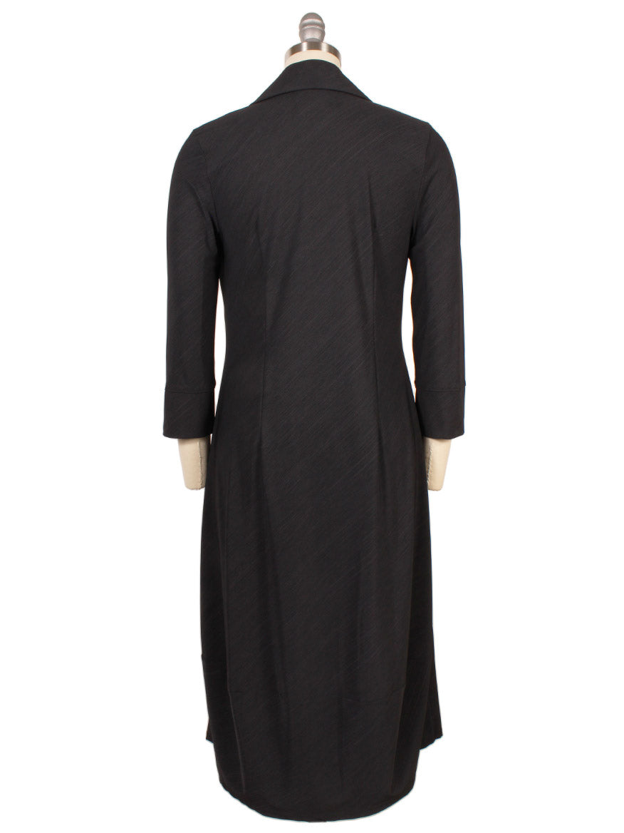 The Porto Flavia Dress in Smoke Reggio, displayed from the back on a dress form, features a split lapel collar and three-quarter sleeves. Made in Italy.