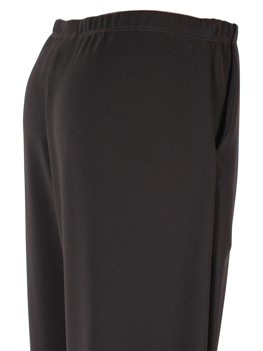 Close-up of Porto Holiday Crepe Pant in Black fabric with an elastic waistband.