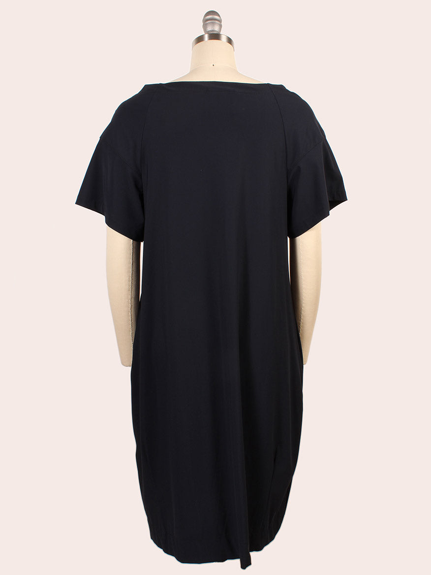 The Porto Kimiko Flutter Sleeve Dress in Shadow features a wide boatneck and knee-length cut, shown from the back on a mannequin against a plain light background.