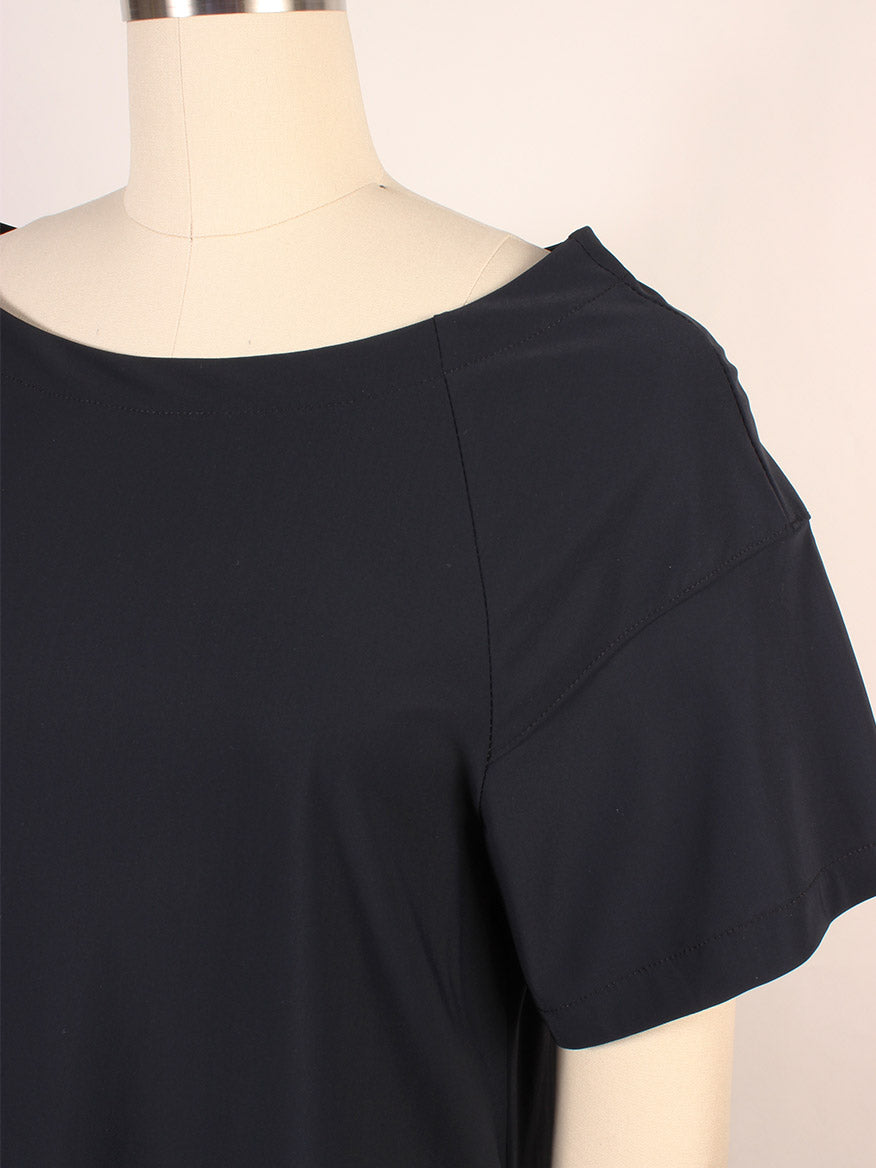 A close-up of the Porto Kimiko Flutter Sleeve Dress in Shadow on a dress form, highlighting the wide boatneck, neckline, shoulder, and upper chest area.