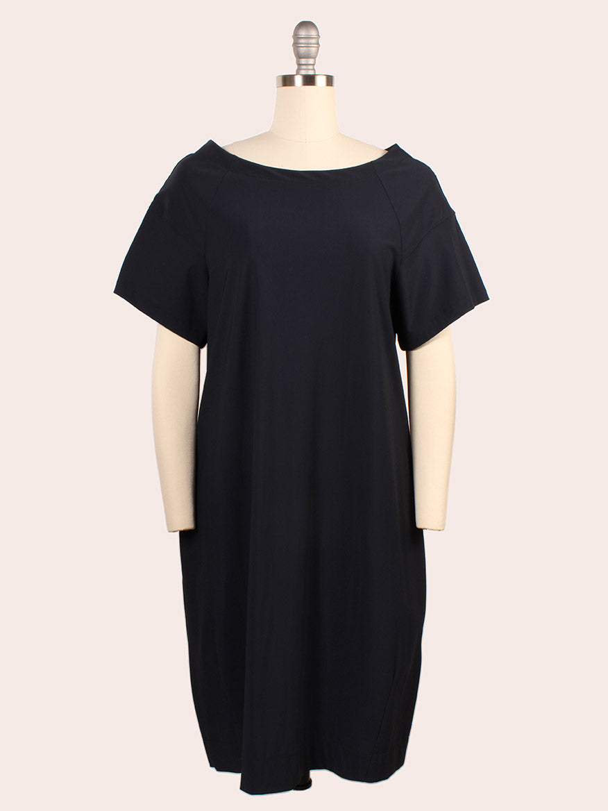 The Porto Kimiko Flutter Sleeve Dress in Shadow features a knee-length silhouette with flutter sleeves, shown on a dress form against a plain background. Expertly made in Italy.