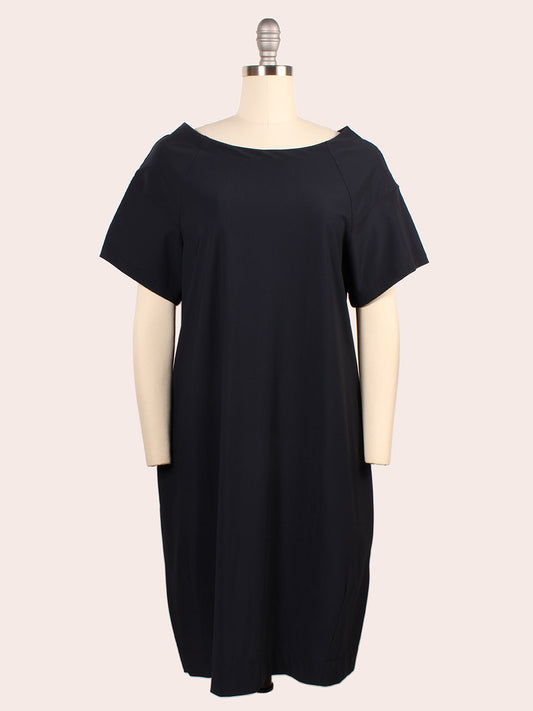 The Porto Kimiko Flutter Sleeve Dress in Shadow features a knee-length silhouette with flutter sleeves, shown on a dress form against a plain background. Expertly made in Italy.