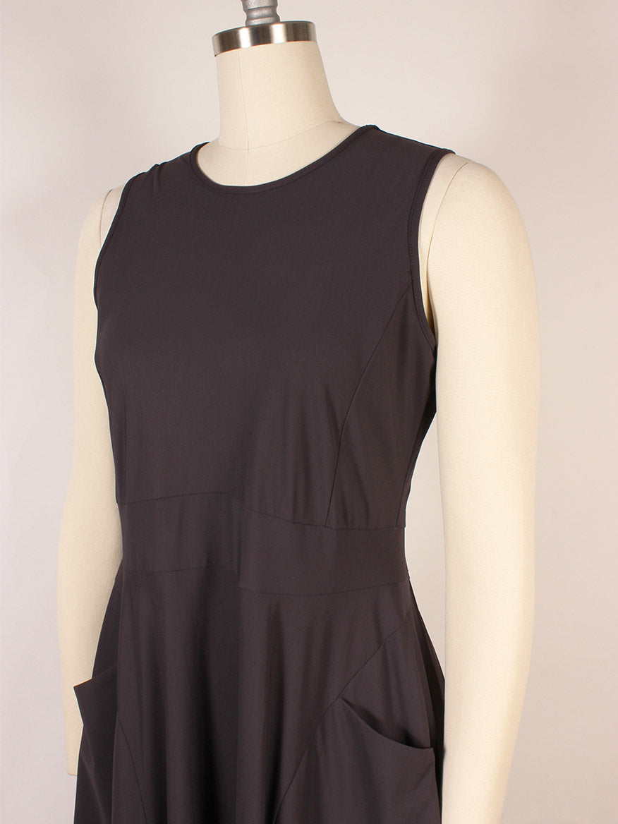 Porto Lydia Dress in Mulberry, made in Italy, shown on a dress form with a round neckline, two front pockets, and a chic mesh ruffle hem.