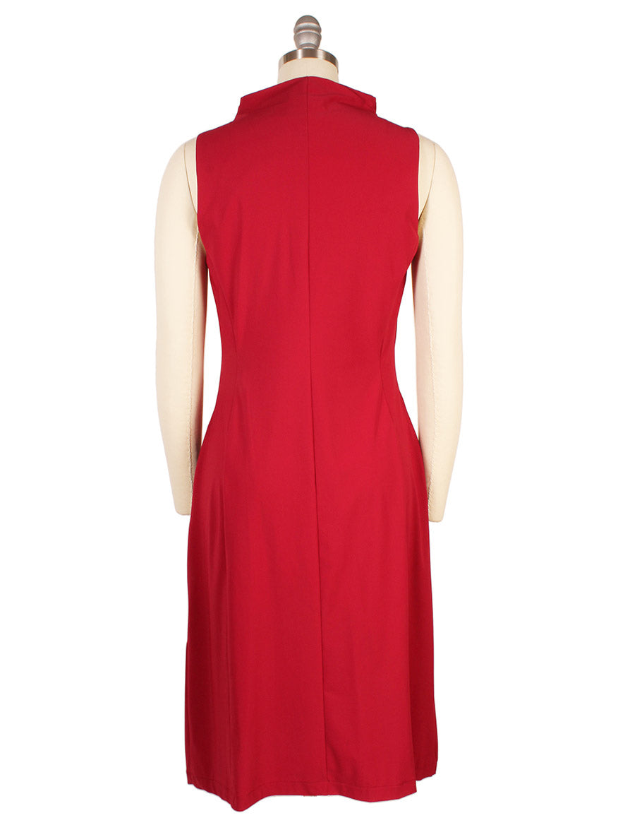 The Porto Nina Dress in Garnet is a sleeveless, knee-length dress with a funnel neckline, made in Italy. Shown from the back on a mannequin against a white background.