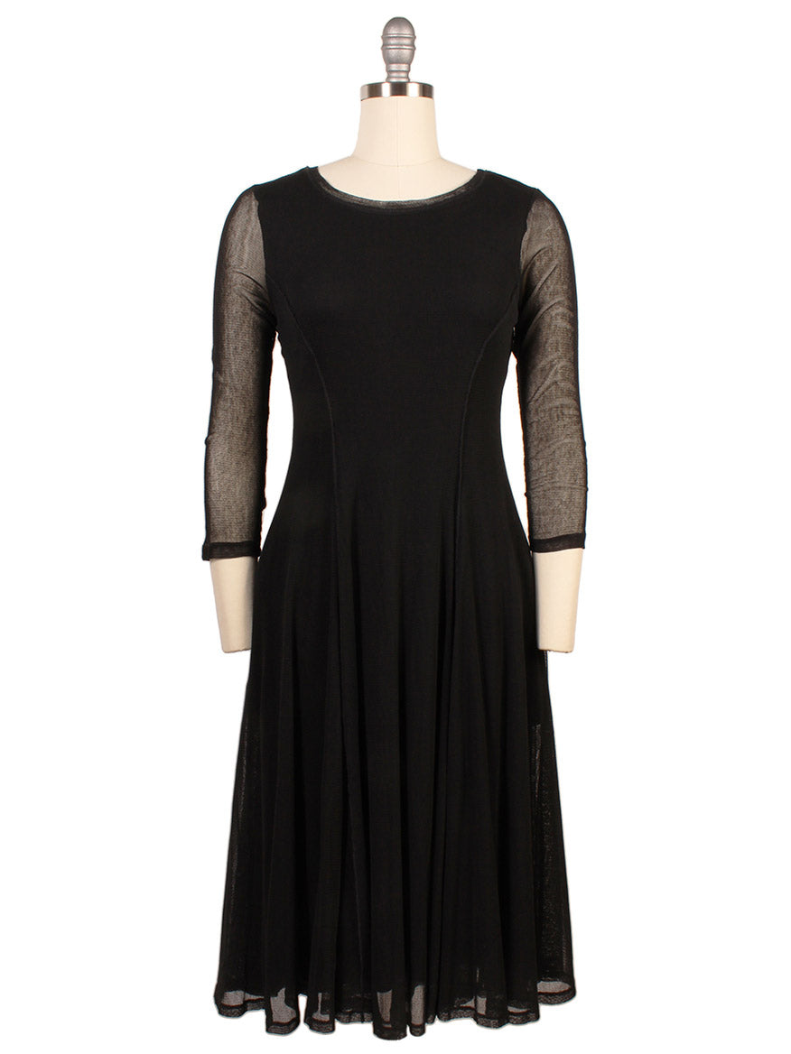 The Porto Pendulum Dress in Black features a fit-and-flare silhouette with sheer mesh three-quarter sleeves, a fitted bodice, and a flared skirt, shown here on a dress form.