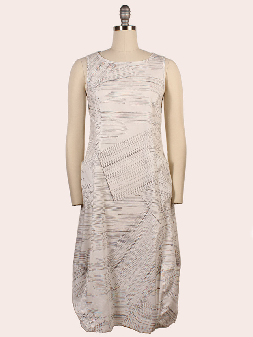 The Porto Santiago Sleeveless Dress in Quail Laguna, featuring a boat neckline and abstract thin line pattern, is displayed on a dress form against a plain background. Made in Italy.