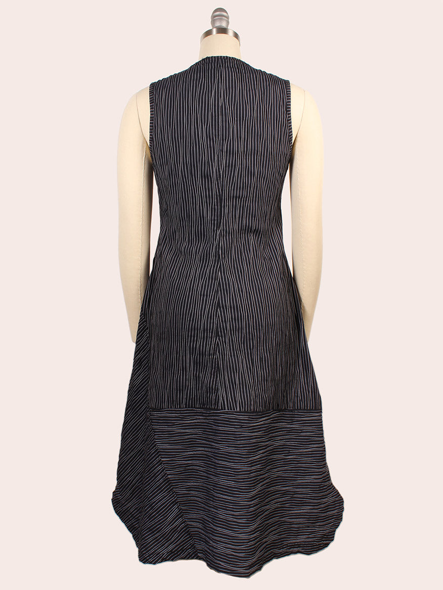 The Porto Trophy Nagoya Stripe Sleeveless Dress in Navy is displayed on a mannequin from the back, showcasing fine vertical and horizontal black, blue, and white stripes in luxurious Nagoya stripe fabric.
