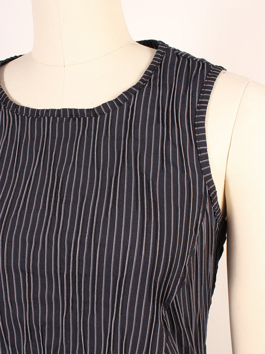 The Porto Trophy Nagoya Stripe Sleeveless Dress in Navy features vertical black and white pinstripes on Nagoya fabric, sleeveless design, elegantly showcased on a mannequin torso. Made in Italy.