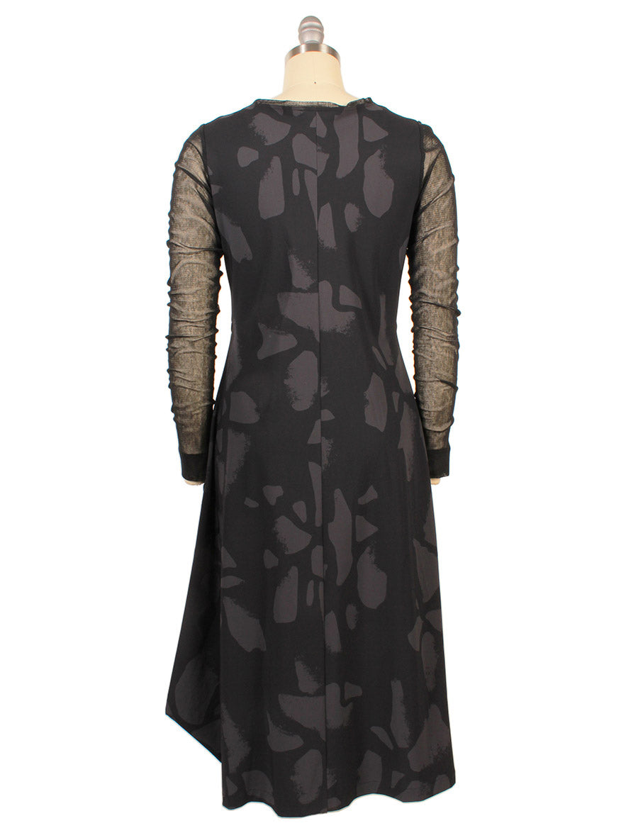 The Porto Venetian Dress in Smoke Palermo features mesh long sleeves and an abstract dark gray pattern. Displayed on a dress form from the back. Made in Italy.