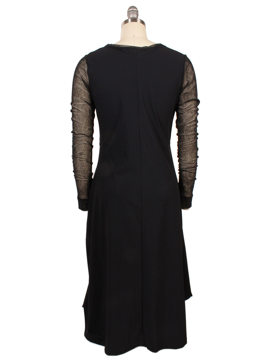 The Porto Venetian Dress in Black is a knee-length, fitted dress with mesh long sleeves, shown from the back on a dress form. Made in Italy.