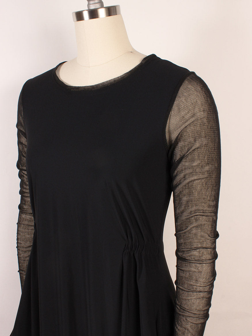 The Porto Venetian Dress in Black, displayed on a mannequin, features mesh long sleeves and gathered waist detailing. Made in Italy.