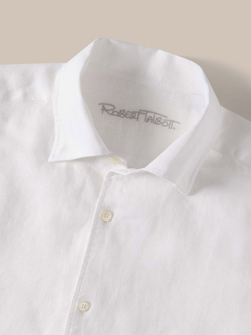 The Robert Talbott Morgan Linen Shirt in White features a spread collar and lightweight, breathable French linen for effortless style. The signature "Robert Talbott" label accents the inside.