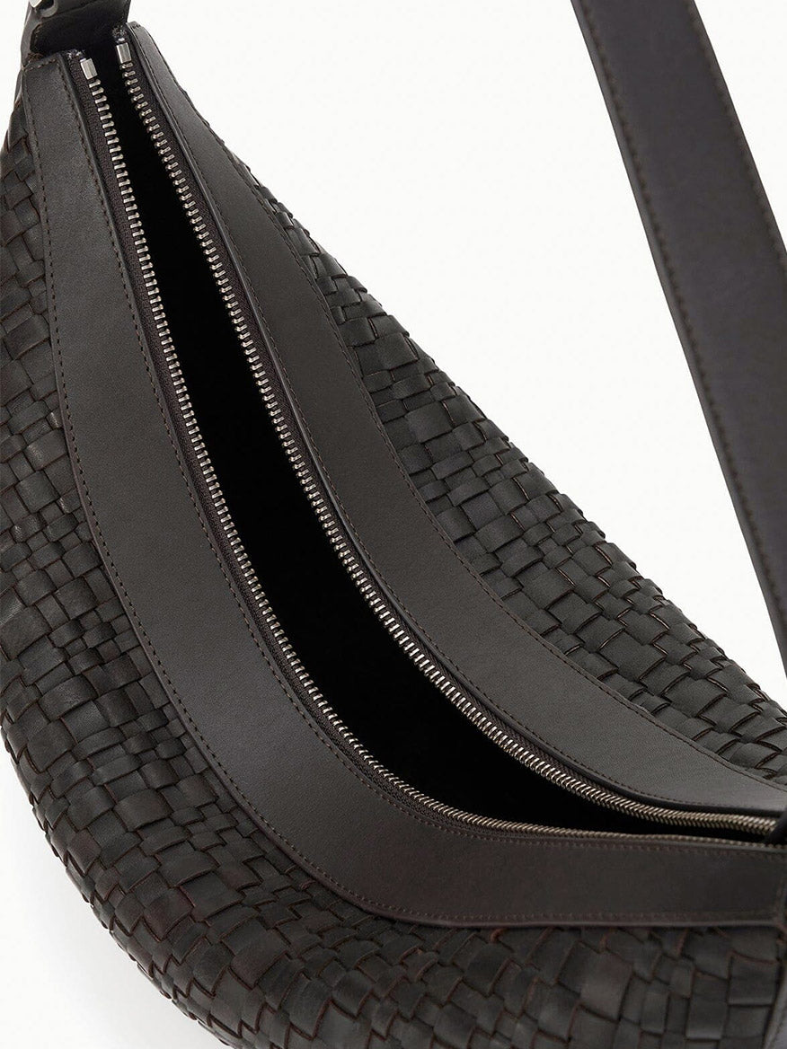 Close-up of the STAUD Large Demy Shoulder Bag in Espresso, a black woven leather hobo with adjustable shoulder strap and partially open zipper, showcasing its rich texture and detailed stitching.