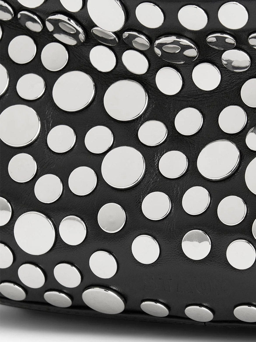 Close-up of the STAUD Demy Shoulder Bag in Rivets, showing black nappa leather adorned with scattered round, flat silver studs in various sizes.