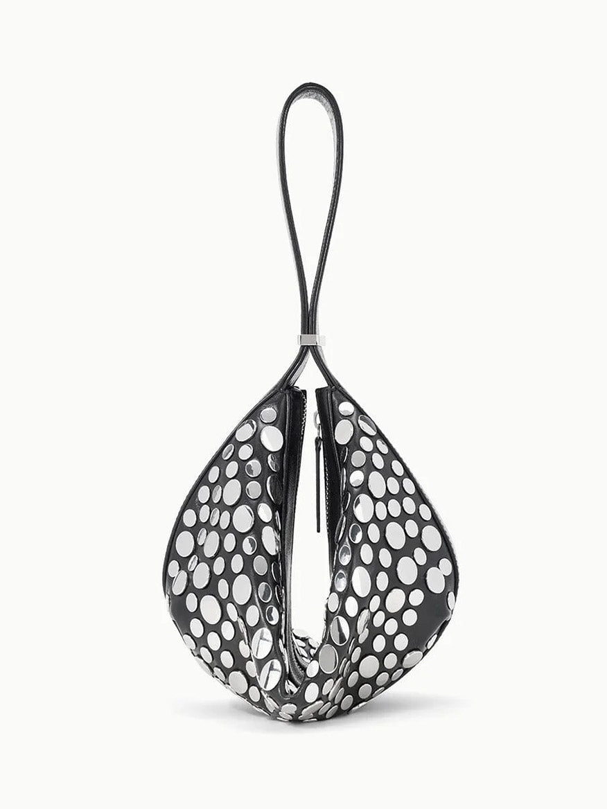 The STAUD Demy Shoulder Bag in Rivets features a black and white teardrop shape, large polka dots, a single top loop handle, and is crafted from soft nappa leather.