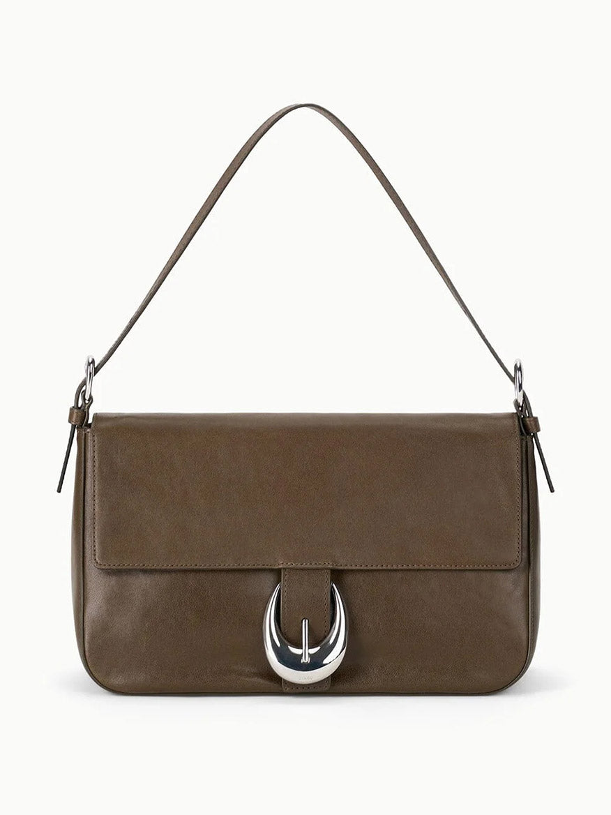 The STAUD Harlow Medium Bag in Truffle is a brown leather shoulder bag featuring a short strap, flap closure, and a distinctive Moon buckle on the front.