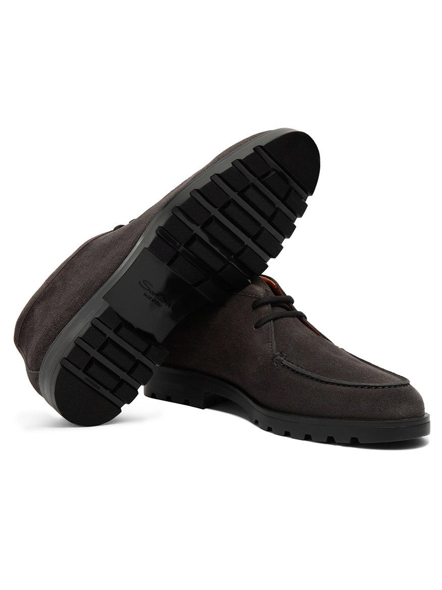 A pair of Santoni Desert Lace Up Boots in grey suede, featuring thick, textured black rubber soles—one boot upright and the other angled to display the sole.