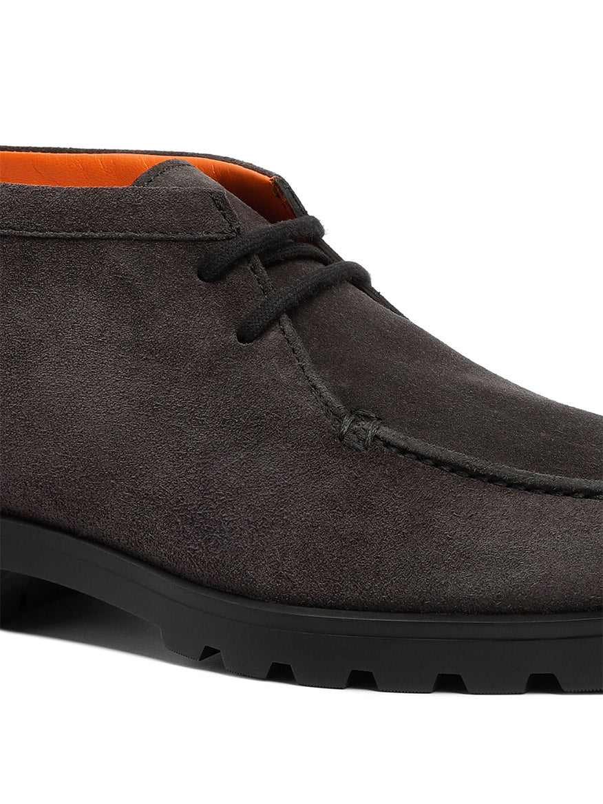 Close-up of the Santoni Desert Lace Up Boot in grey suede, made in Italy, featuring a black rubber sole, visible stitching, and a vibrant orange inner lining.