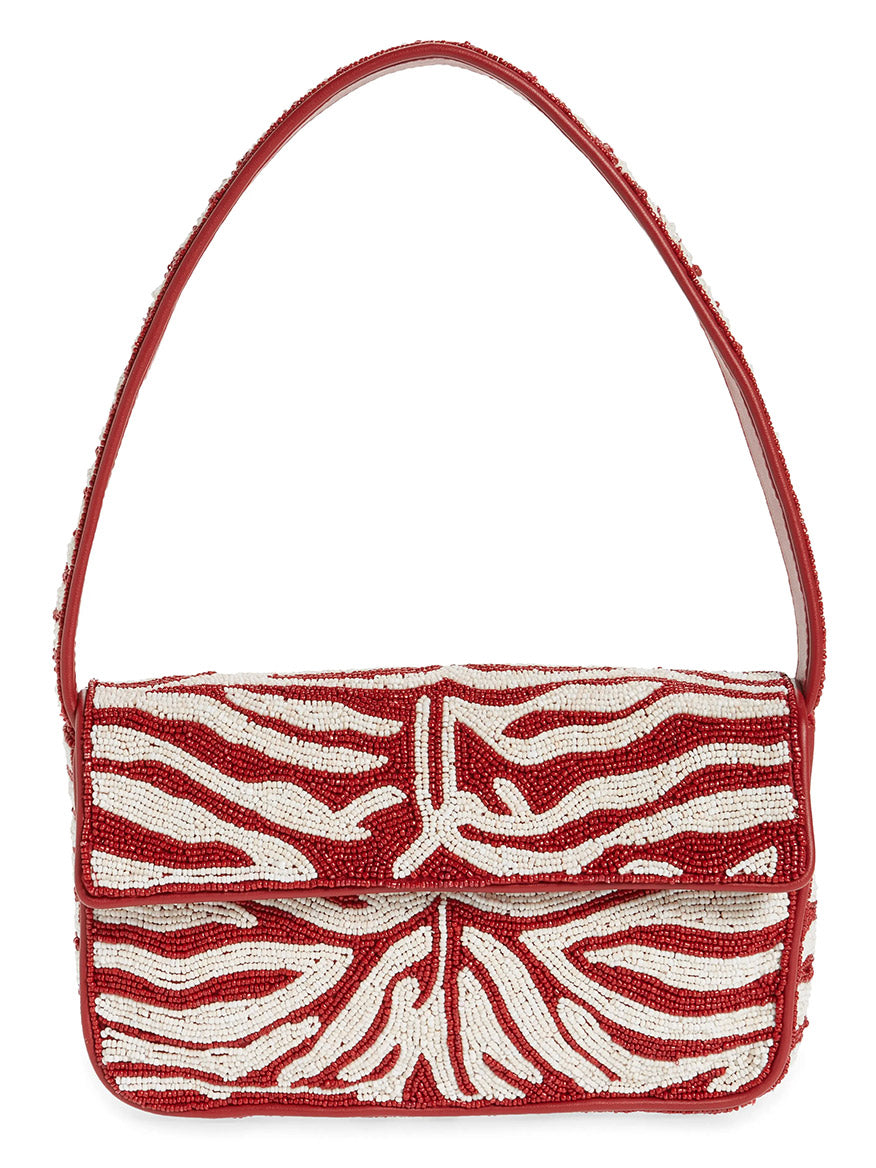 The STAUD Tommy Beaded Bag in Scarlet/White Zebra is a hand-beaded shoulder bag with a single strap, showcasing a red and white abstract zebra pattern on vegan leather.
