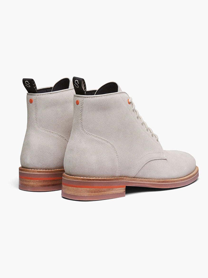 The Swims Oslo Boot in Mist is a light gray suede lace-up ankle boot with bloom algae insoles, waterproof Italian leather, wooden soles, and black heel tabs, viewed from the side.