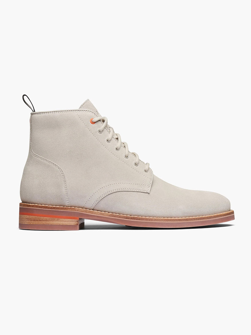 The Swims Oslo Boot in Mist is a beige suede boot with a leather sole, crafted from luxurious Italian leather and featuring a black pull tab, shown from the side against a white background.