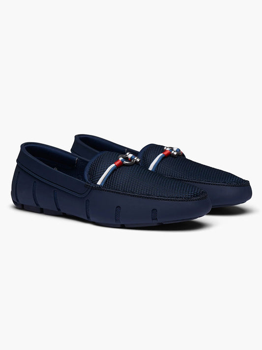 Pair of blue Swims Riva loafers with lace detail on a plain background.