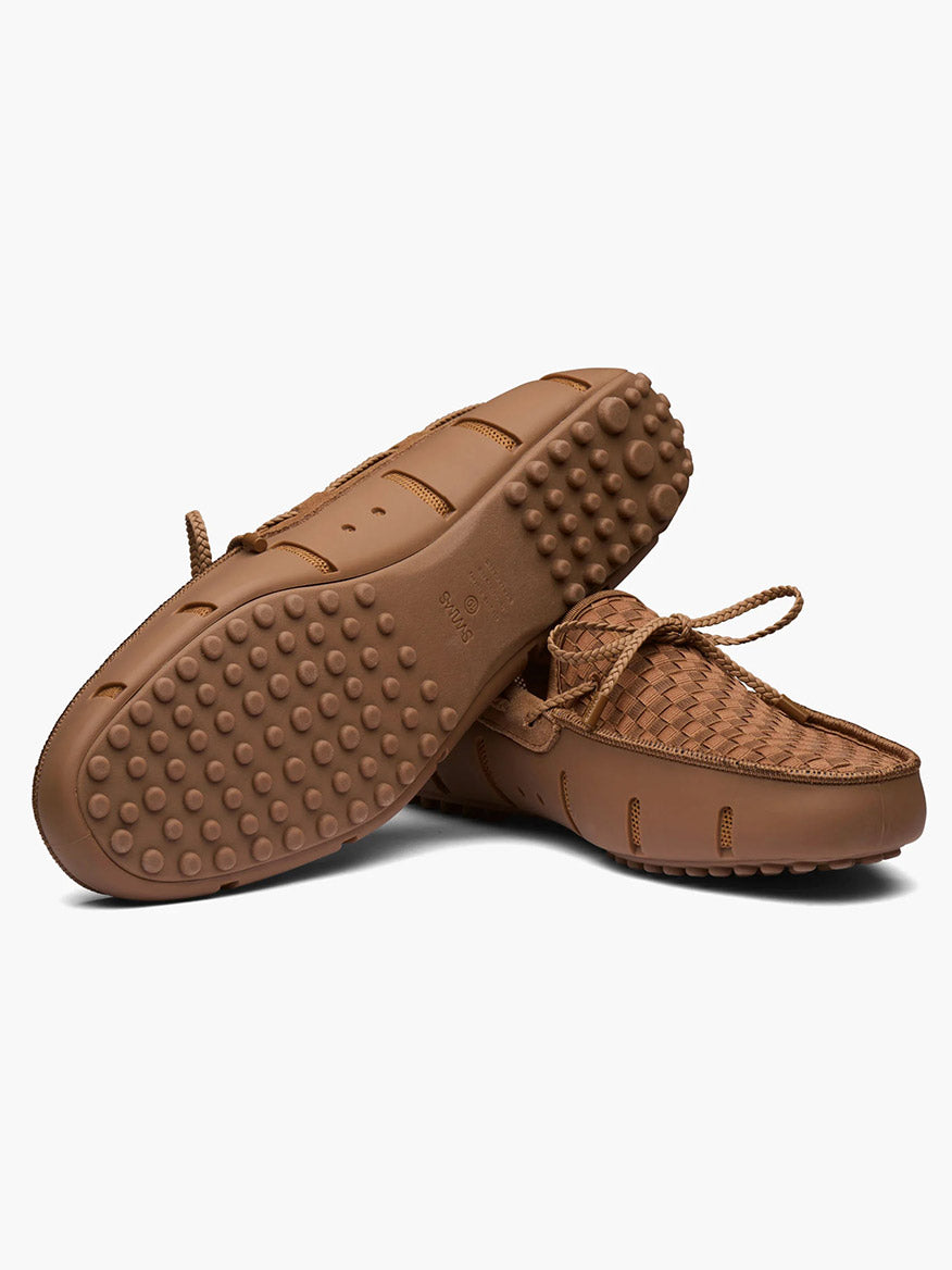 The Swims Woven Driver in Nut features a water-friendly brown woven design, textured rubber pebble sole, and round grip studs—shown with one shoe upright and the other on its side to display both top and bottom views.