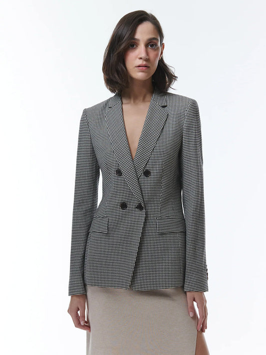 Woman wearing THEO The Label Eris Baby Houndstooth Blazer in Black/Ivory.