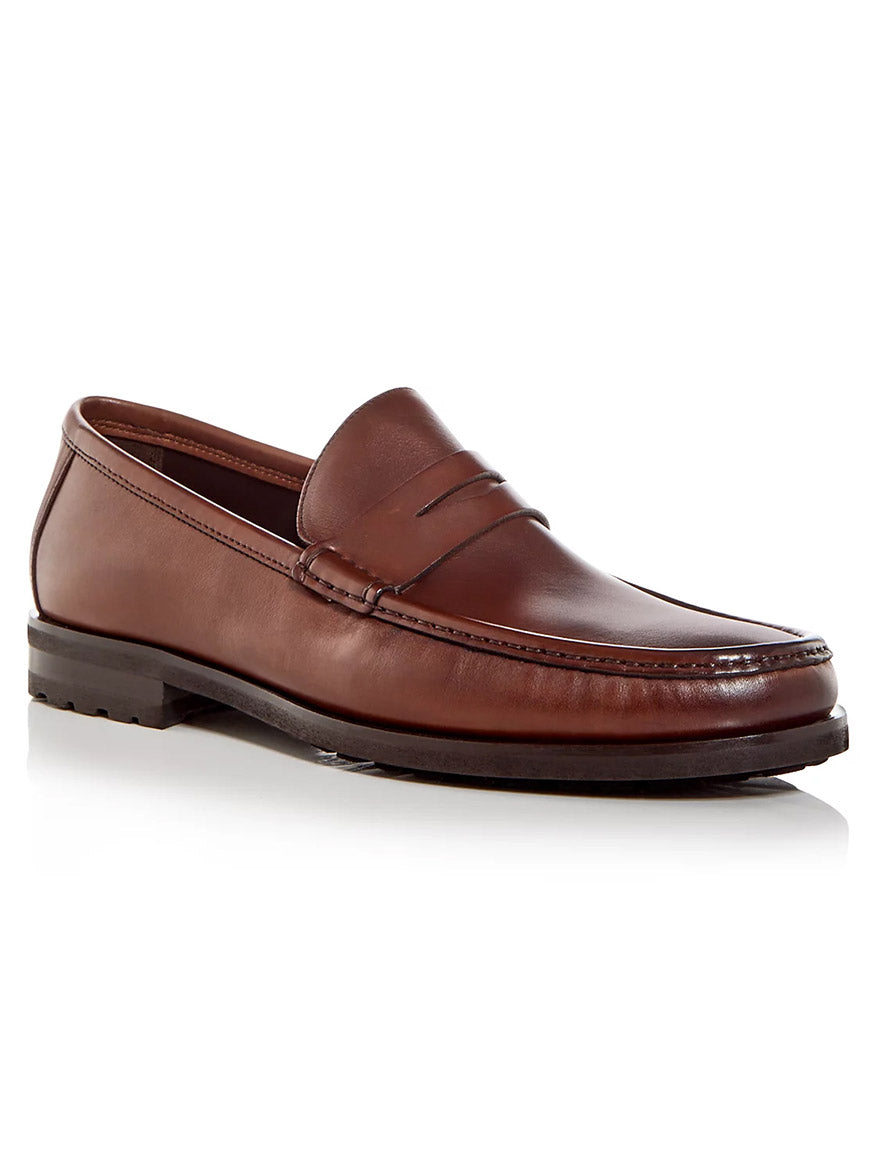 The To Boot New York Belfast in Cognac is a men's Italian leather penny loafer with stitching detail and a low heel, ideal for dress or smart casual wear, shown on a white background.