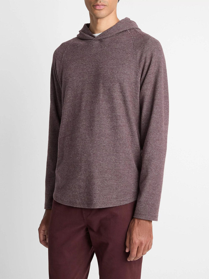 A man wears the Vince Broken Twill Pullover Hoodie in Port/Heather Grey, made from a soft modal and cotton blend, paired with matching pants, standing against a plain white background.