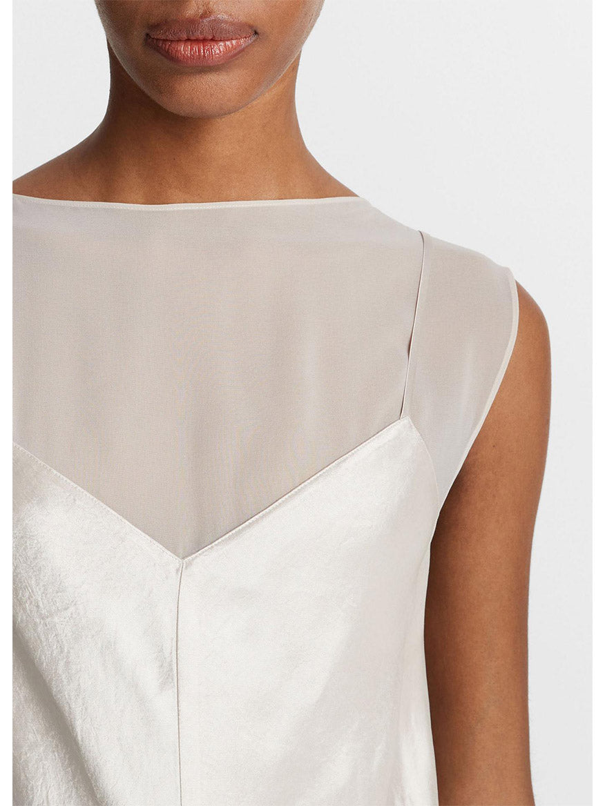 Close-up of a woman in a Vince Chiffon-Layered Satin Slip Dress in Champagne, focusing on the detailed neckline and shoulder seam.