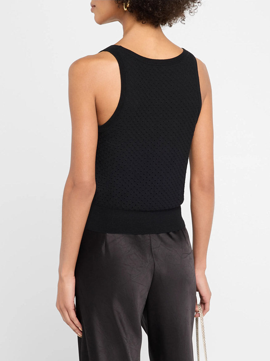 A person shown from the back against a light background wears the Vince Italian Cotton-Blend Mesh Double-Layer Tank in black, sleeveless with a scoop neck, paired with dark satin pants.