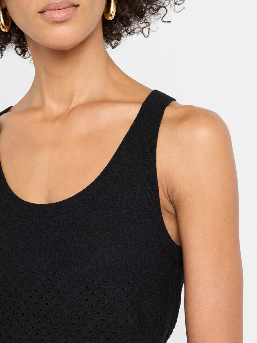 Close-up of a woman wearing the Vince Italian Cotton-Blend Mesh Double-Layer Tank in Black with gold hoop earrings, shown from her shoulders to just above her lips.