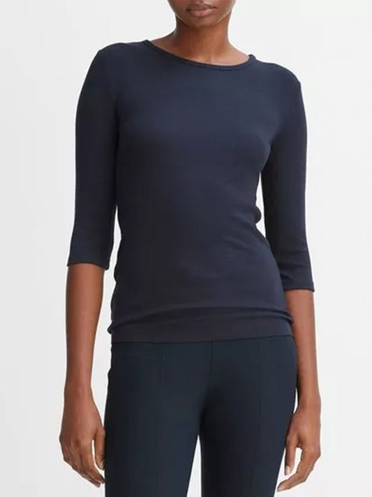 Woman wearing a dark blue Vince Elbow Sleeve Crew Neck T-shirt in Coastal with matching pants.